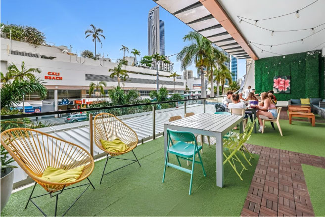 Backpackers hanging out on the balcony at Tequila Sunrise Hostel Gold Coast